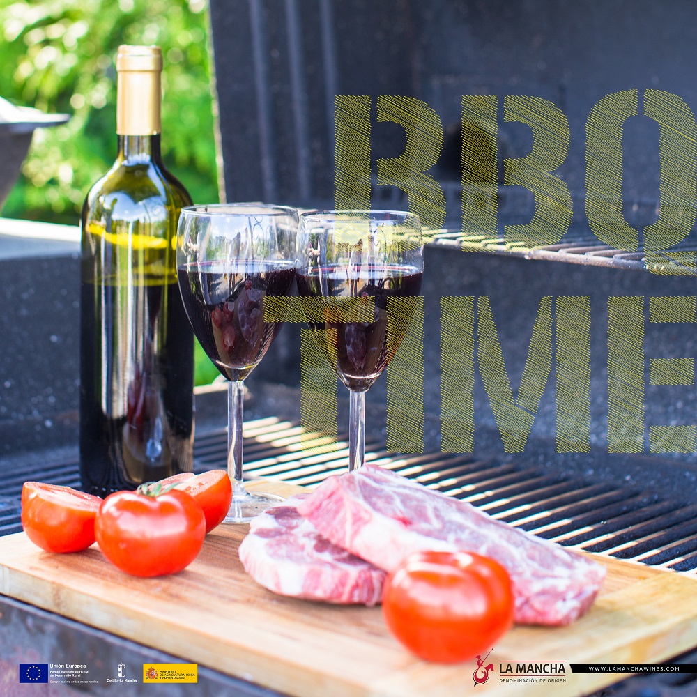 Bottle of red wine, steak and tomatoes on barbecue outdoors