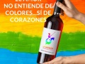 Hands holding bottle of wine with blank label on dark background. Mockup for design
