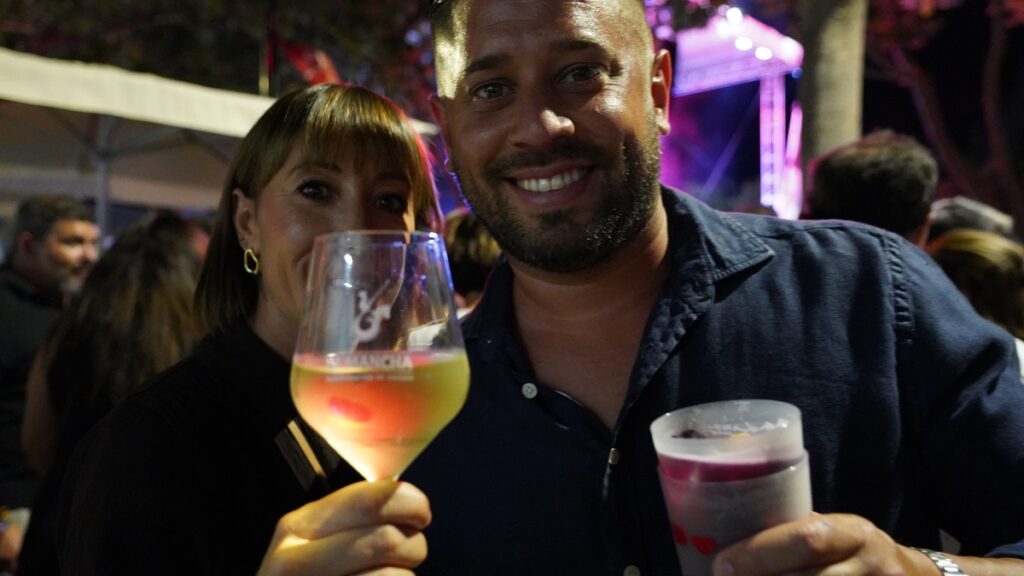 Una joven pareja posa con un vino de La Mancha